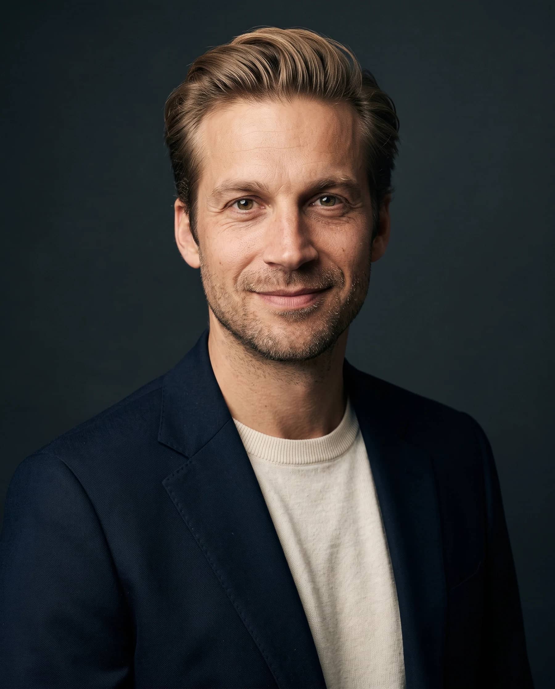 AI-generated studio portrait of cofounder Mathieu Wauters in a navy jacket and cream tee