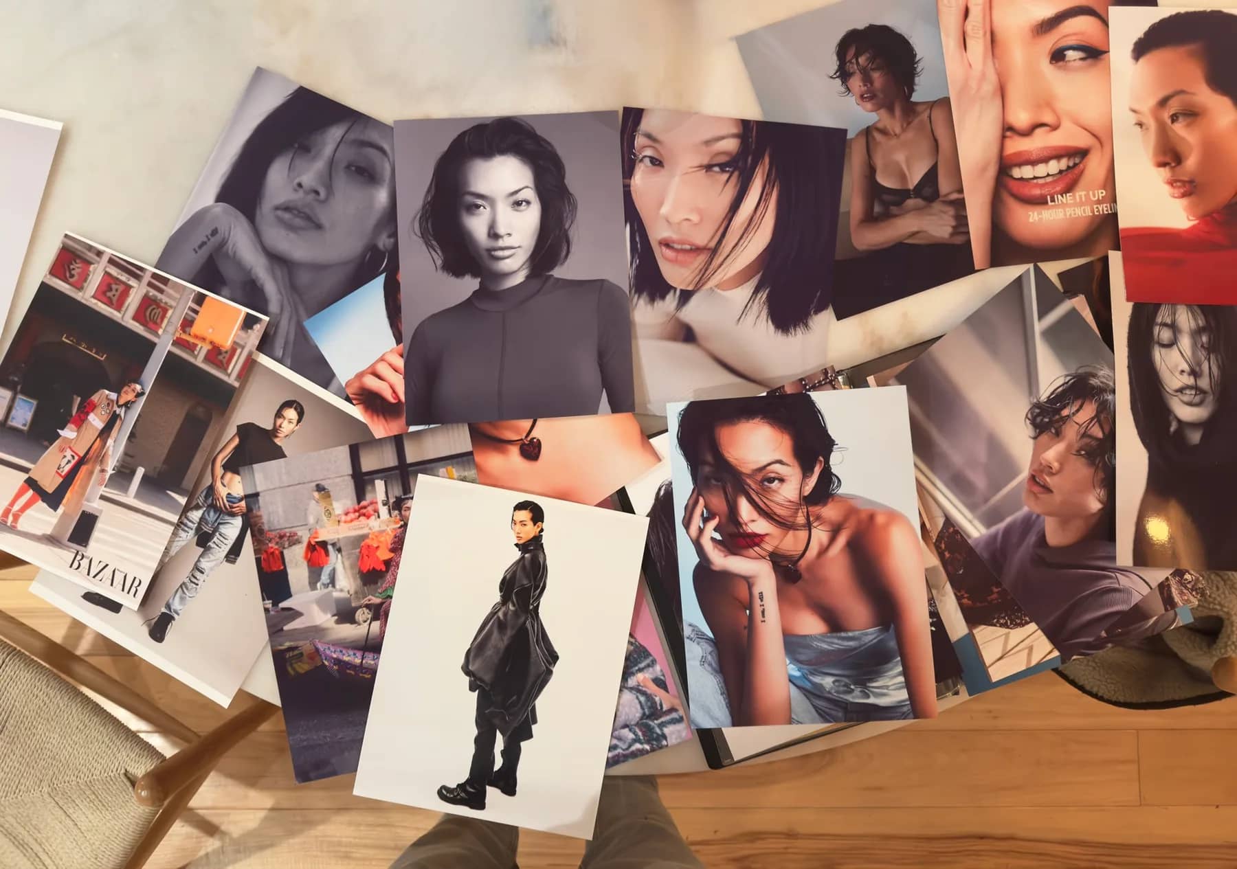 Spread of Piyawan Chitsamran’s modeling comp cards and editorial tear sheets