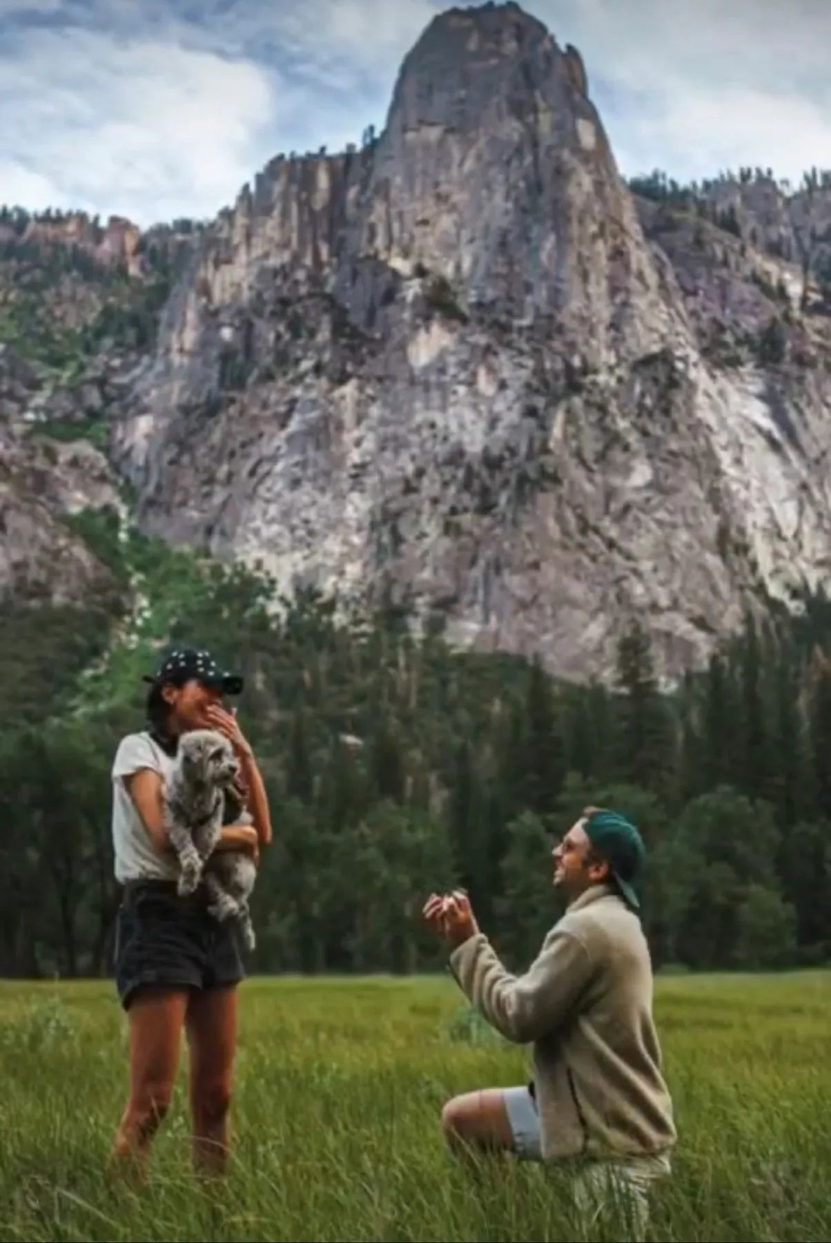 Mathieu Wauters proposing to Gift on one knee in a mountain valley meadow