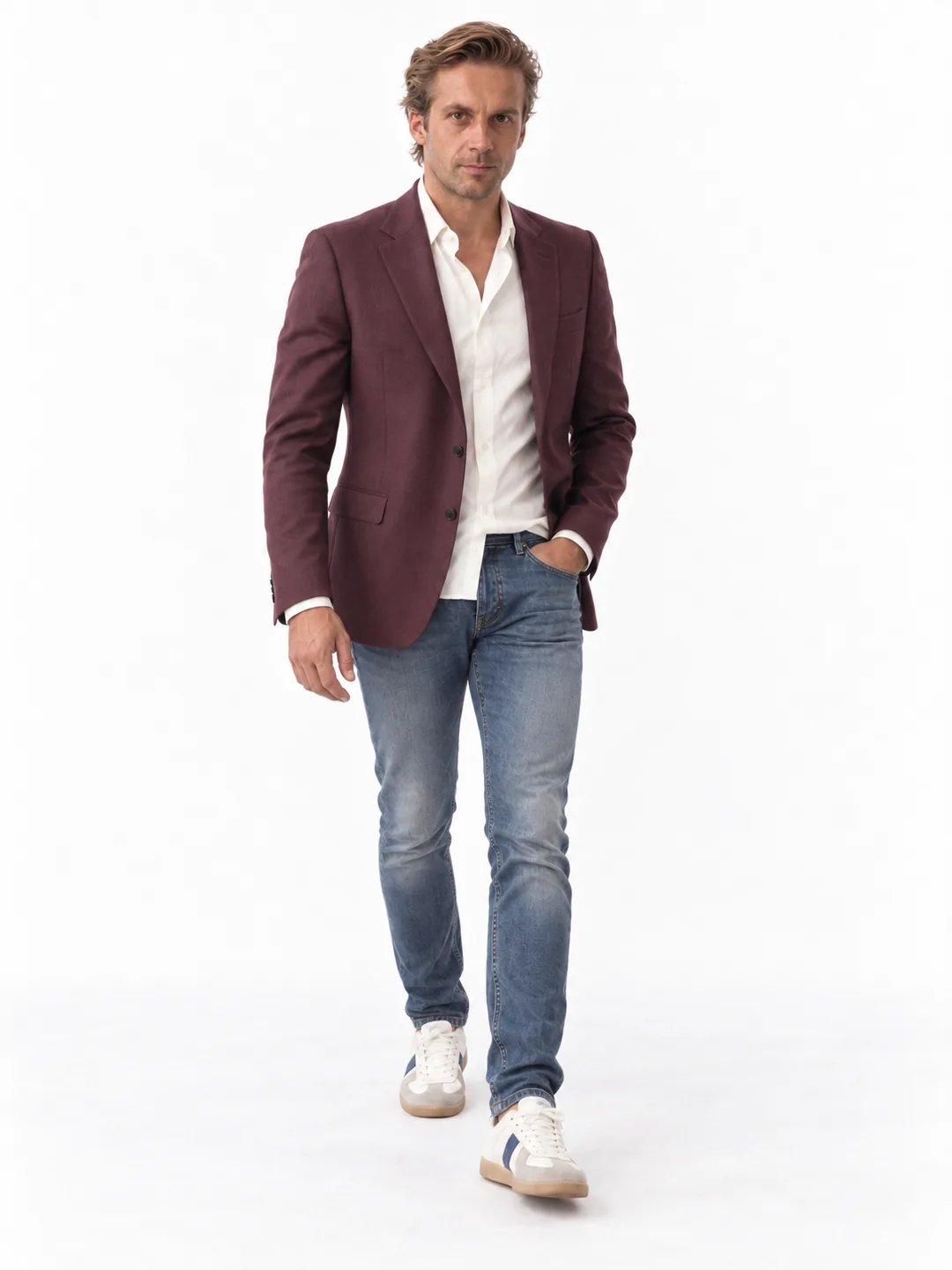 AI-generated full-length studio photograph of Mathieu walking toward the camera in a burgundy blazer