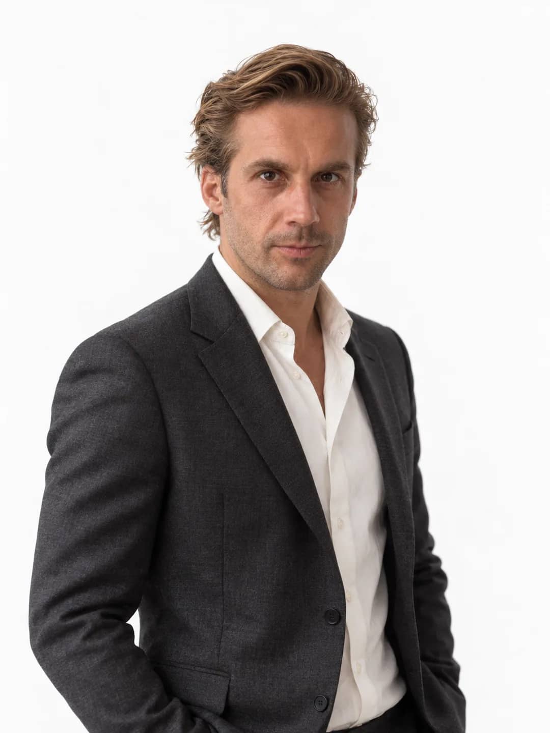 AI-generated studio portrait of Mathieu in a charcoal suit and open white shirt