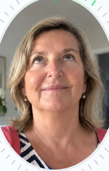 The same woman holding her phone, looking up